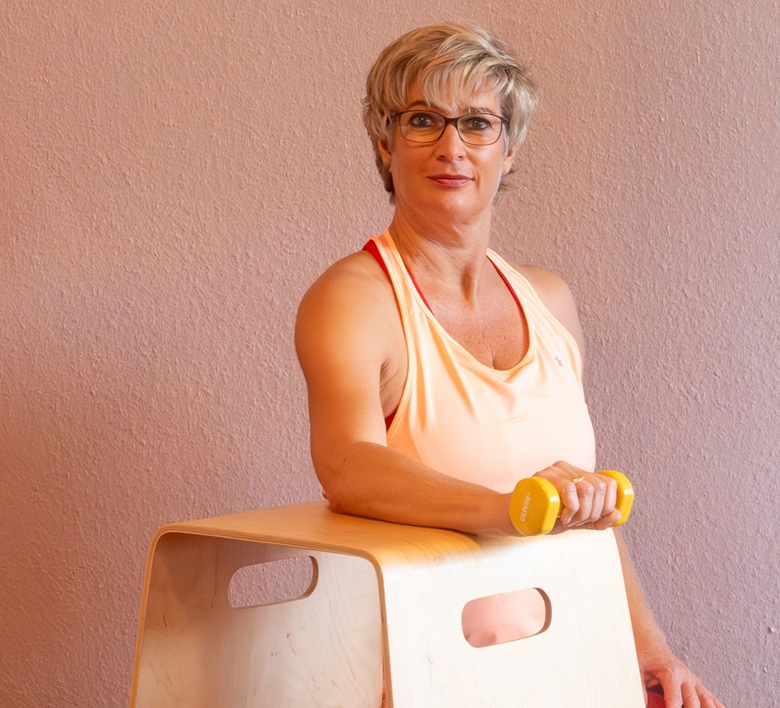 1fach Yoga | 1fach Gesund - Spiraldynamik Workshops - Gesunde Hände und Ellenbogen - Silke Wagner mit Kleinhantel, Arm auf Hocker